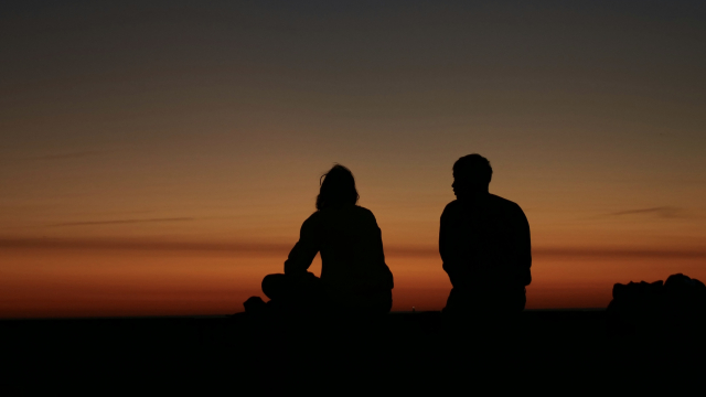 sunset_silhouettes_conversation_hillside_unsplash